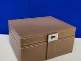 an image of a brown leather jewelry box on a white table