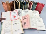 several open books sitting on top of each other on a table