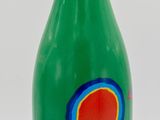 bottle of green liquid with red and blue designs on it