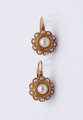 deux paires de boucles d'oreilles en perles et en or posées sur un fond blanc