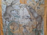 a yellow scarf with a picture of animals on it