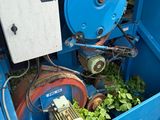 a blue machine that has a bunch of plants inside of it