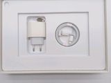 a white box with a charger and a cable attached to it