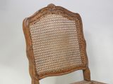 a wooden chair with a wicker back and seat
