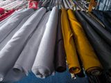 a lot of different colored umbrellas hanging on a rack