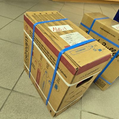 two boxes that are sitting on the floor together