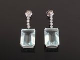 a pair of aquamarinee and diamond earrings
