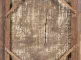 an old wooden picture frame with a hole in the middle of it