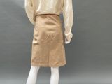 a mannequin mannequin wearing a gold skirt and blouse