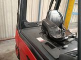 a fork lift truck with a seat on the back of it
