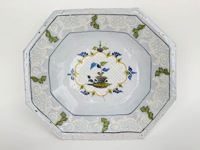 a plate with a bird on it on a white table