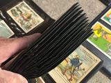 a person holding a comb in their hand in front of a pile of cards
