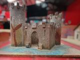 a small model of a castle on a red table