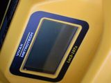 a close up of a yellow motorcycle with a digital display