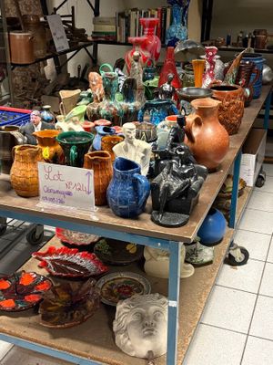 many different vases on a table in a room
