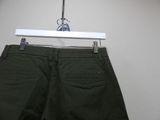 a pair of green pants hanging on a hanger