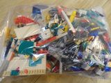 a bag of legos sitting on a wooden table