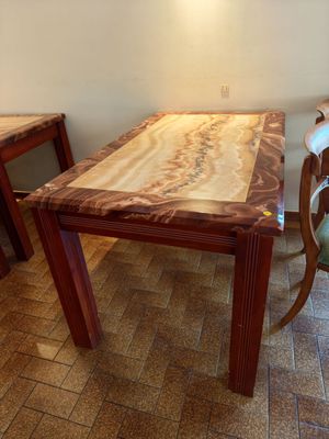 a wooden table and chairs in a room with tile flooring