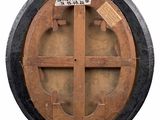 a wooden circular window with a sign on it