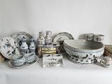 a white table with a lot of dishes and bowls on it