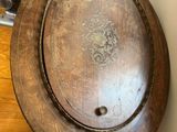 a wooden plate that is sitting on top of a chair
