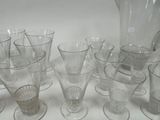 a lot of glasses and a pitcher on the table