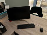 a computer on a desk with a keyboard and mouse