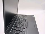 a laptop computer sitting on a table with a keyboard