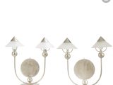 three lamps with shades on each of them on a white surface
