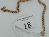a close up of a gold chain with a tag on it