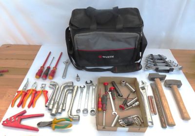 un sac d'outils posé sur une table à côté d'une paire de pinces