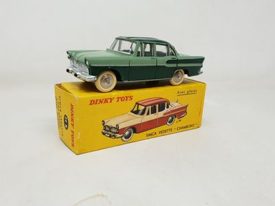 toy car sitting on top of a box on a white surface