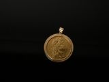 a close up of a gold coin on a black background