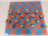 a blue and red checkered board with small figurines on it