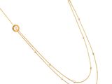 a gold necklace with a knot and a circle on a chain