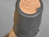 a close up of a bottle of alcohol with a wooden cap