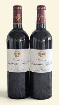 two bottles of wine sitting next to each other on a table