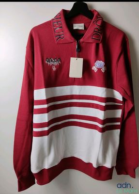 a red and white striped sweater with a tag on it