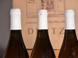 three bottles of wine that are sitting on a table