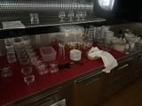 many glasses and plates on the counter in the kitchen