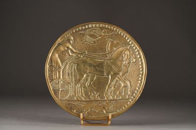 an image of a gold plate with an image of a man on a horse