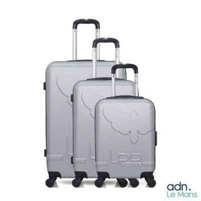three pieces of luggage sitting on top of each other on a white surface