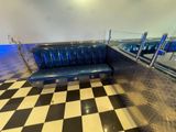 a black and white checkered floor with a blue couch