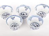 six blue and white bowls with designs on them on a white surface