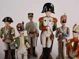 seven figurines of men dressed in military uniforms