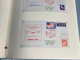 an open book with stamps on it sitting on a table