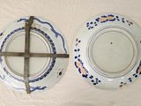 two plates with a cross on them on a table