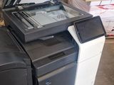 a printer sitting on top of a pile of other printers