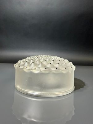a white cake sitting on a table with a black background