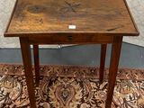 a small wooden table with a drawer on it